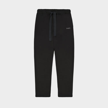 Black cropped sweatpants with drawstring waist and small THEO logo on thigh.