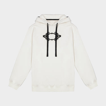 White hoodie close-up with black 3D eye graphic on chest