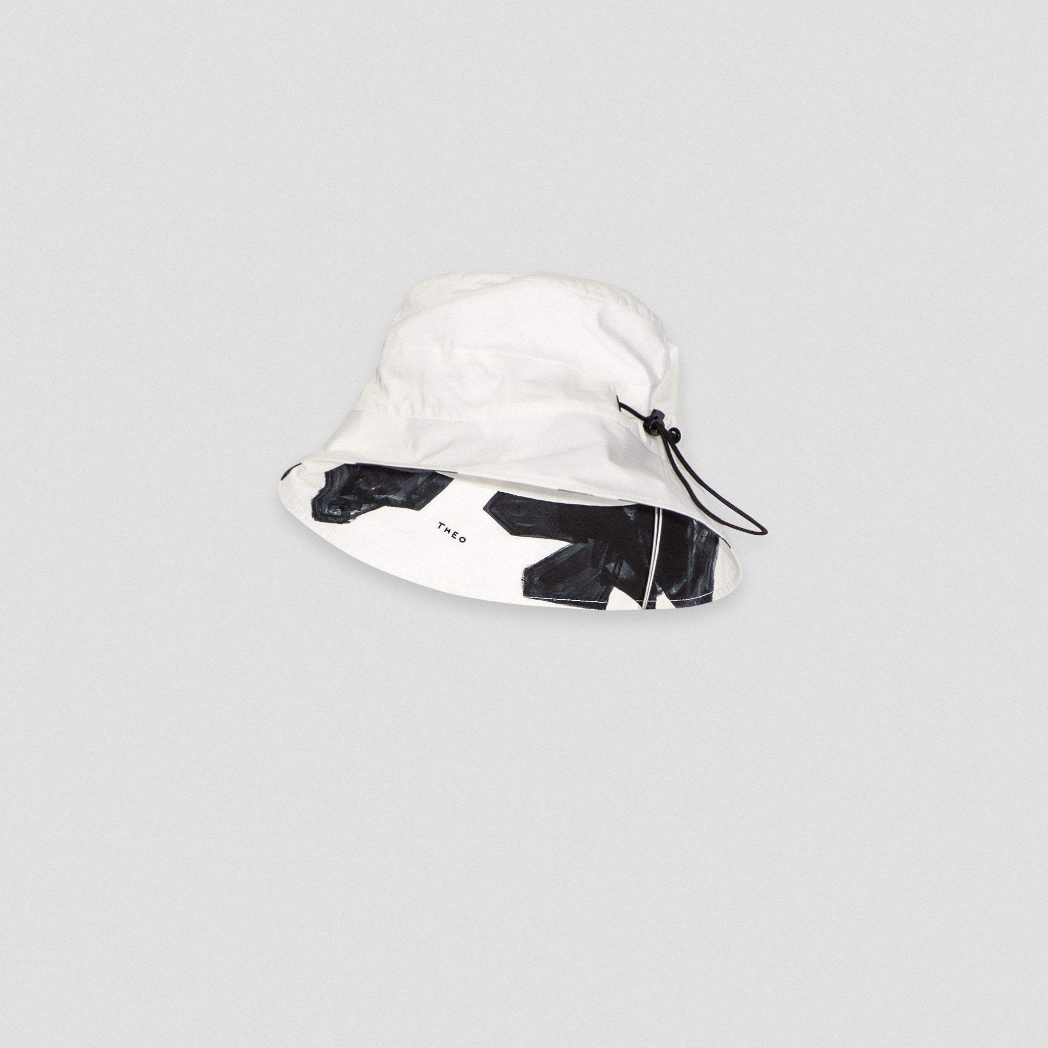 BUCKET HAT WITH DRAWSTRINGS — WHITE AND FLORAL PRINT