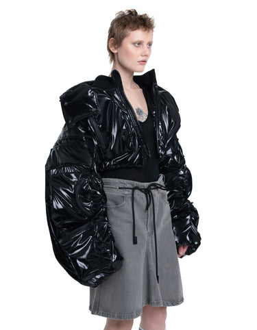 Black hooded cropped puffer jacket, three-quarter side view with glossy quilting