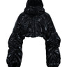 Black cropped puffer jacket with hood, shiny quilted texture and voluminous sleeves
