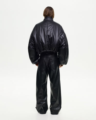 Back view of men's black puffer jacket with oversized sleeves and cropped drawcord hem