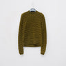 Olive green cable-knit sweater with crew neck and long sleeves
