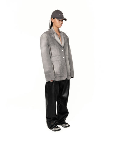 Men's gray denim jacket in profile, button front with zippered flap pocket details