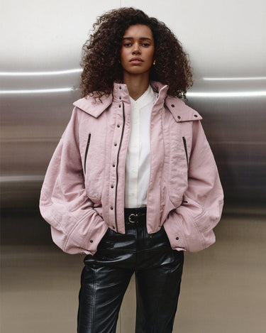 Pink hooded nylon jacket with flap pockets and snap collar, worn on model