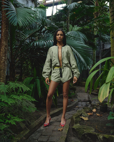 Light green bomber jacket worn front view, featuring front zipper and elastic cuffs