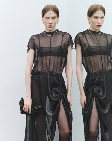Black sheer dress with short sleeves, high neck, and waist-tie drape
