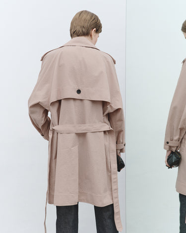 Nude textured trench coat back with belt tie and buttoned yoke.