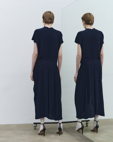 Navy fluid midi dress with tie detail and side slit, back view (no cuffs visible)
