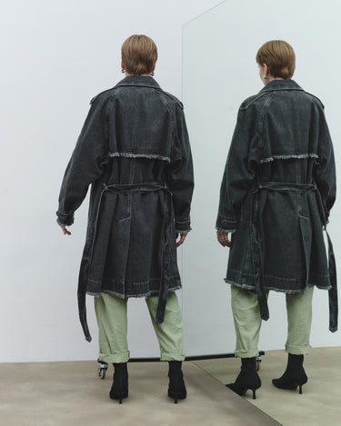 Faded trench coat back view in dark gray with belt tie, seam detailing, and frayed hem.