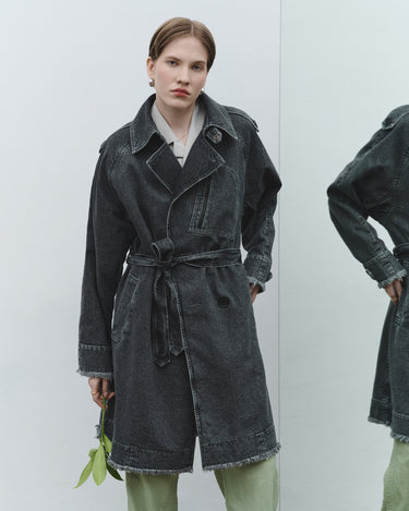 Faded trench coat in dark gray with notched collar, long sleeves, and waist tie belt.