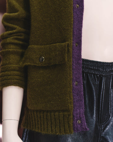 Olive cardigan pocket detail with dark buttons and purple inner placket