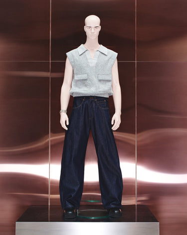 Dark navy jeans with relaxed wide-leg silhouette, front pockets, and button fly