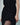 Close-up of the black dress's textured fringe and gathered side slit