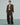 Brown melange blazer worn open with notched lapels and a cropped, boxy cut