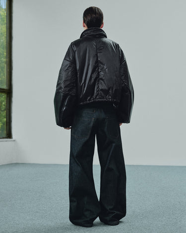 Back view of the cropped black puffer jacket with oversized sleeves
