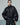 Black puffer jacket with snap front, high collar and oversized leather-look cuffs