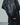 Close-up of the jacket's oversized sleeve with a textured black leather-look cuff