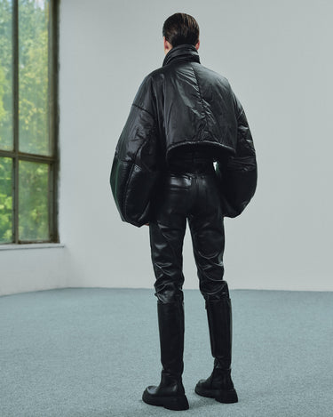 Cropped black puffer jacket with an oversized fit, shown from the back