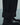 Close-up of black trousers showing wide folded cuffs