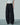 Front view of black wide-leg trousers with an allover fringed texture.