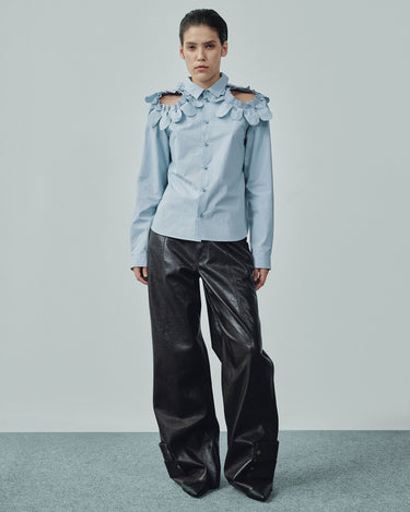 Light blue button-up shirt with petal ruffle shoulder details and long sleeves