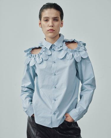 Light blue button-up shirt with oversized petal ruffle neckline and shoulder accents