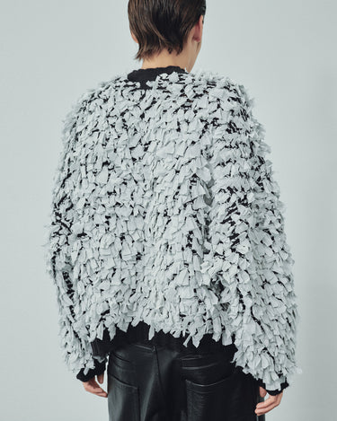Back view of ivory shredded sweater with crew neck and long fringed layered texture