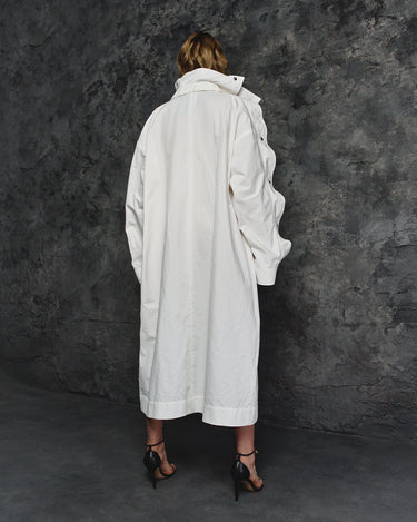 White long balmacaan coat with back yoke and buttoned cuffs, back view