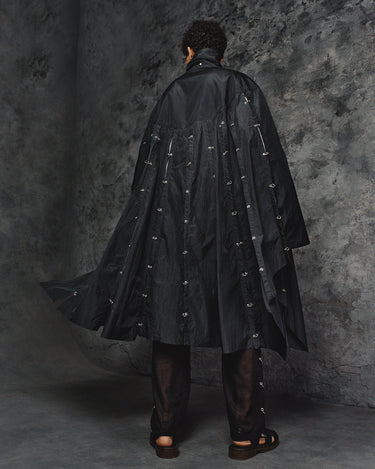 Long hooded dark cape, back view, full cape length with silver snap pattern