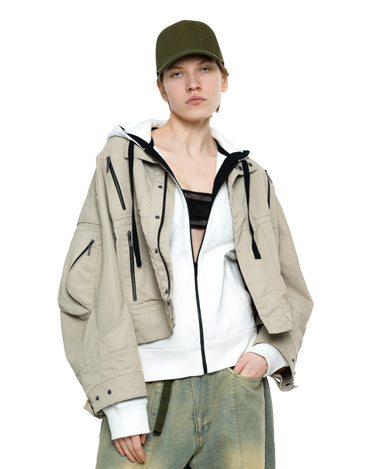 Khaki THEO cap with curved brim and small front logo, worn with hooded jacket
