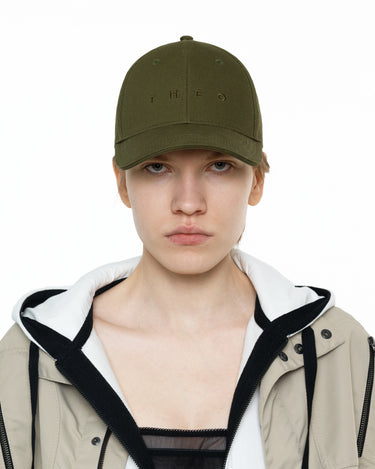 Khaki THEO cap with small front logo; keychain strap visible