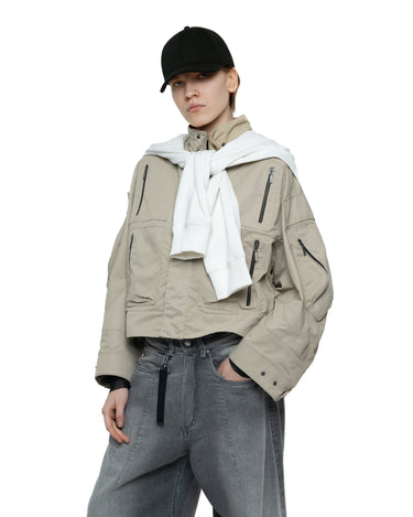 Black baseball cap with curved brim, styled with a white scarf and beige jacket