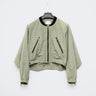 Light green cropped bomber jacket with black collar, front zipper, and zip pockets