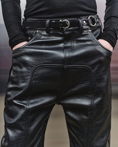 Men's black faux-leather trousers waistband with belt loops and silver buckles