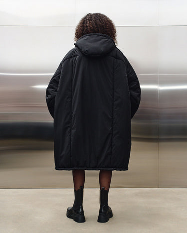 Black hooded puffer coat back view with centered seam and roomy hood