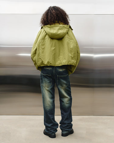Green nylon TMBY jacket back view with hood and gathered shoulders