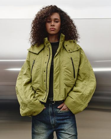 Green nylon TMBY jacket with hood, snap front, and zip pockets