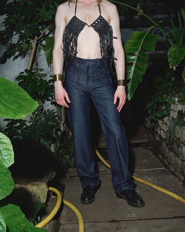 Navy six-pocket denim jeans on model, full-length straight leg view