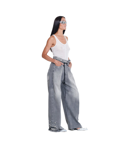 Distressed baggy jeans in light gray denim wash, side view with front drawstring tie