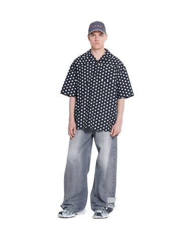 Black printed camp shirt with white dots, camp collar and short button placket.
