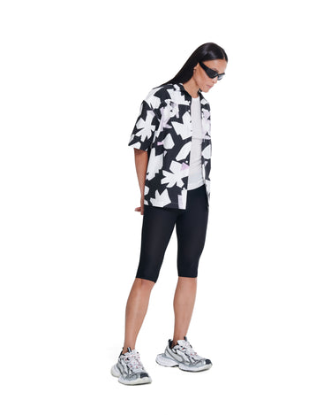 Black-and-white abstract printed camp shirt with short sleeves and button front.