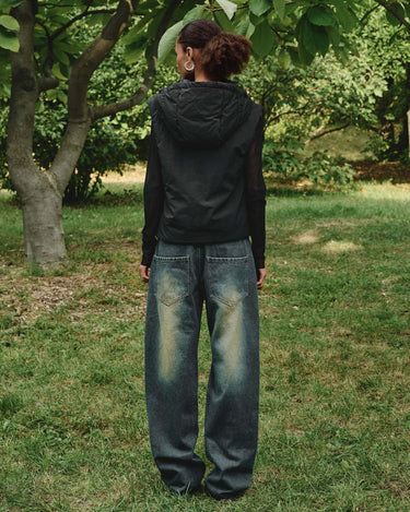 Black hooded vest with hood and full-zip front, back view on model