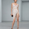 White lace slip dress with spaghetti straps and scalloped hem