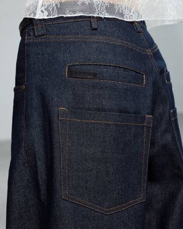 Dark navy jeans detail: contrast-stitched back patch pocket and belt loops
