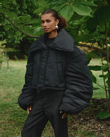Black puffer winter jacket with turn-down collar and snap-front placket
