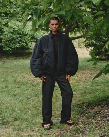 Padded bomber jacket, dark color, stand collar and zip front; relaxed fit.