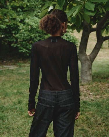 Dark sheer mesh turtleneck top, shown from the back with long sleeves