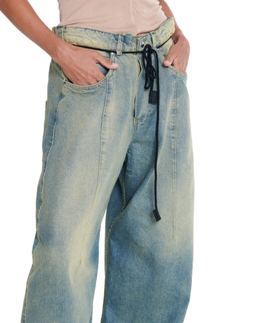 Washed blue distressed baggy jeans with drawstring waist, relaxed straight fit.