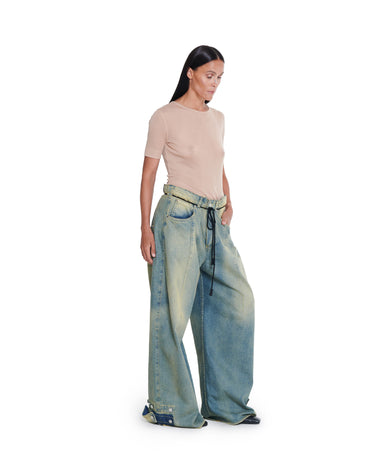 Washed blue distressed baggy jeans with wide legs and visible front seams.